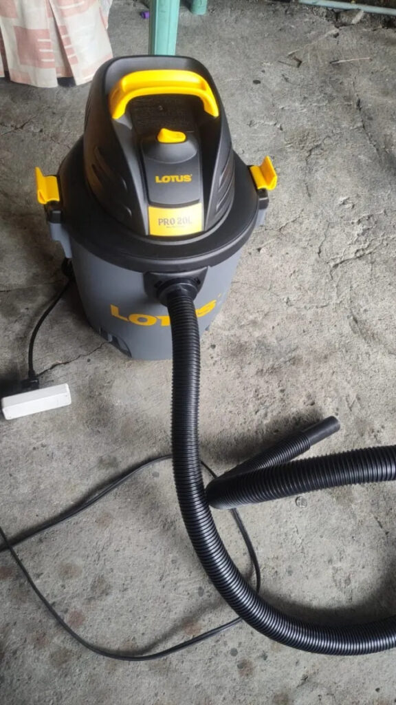 Lotus Vacuum 20L LT1200DWX  with an attached hose, showcasing its functionality for various cleaning applications.