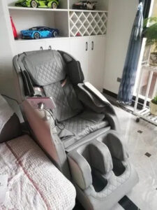 A Benbo XTAM9AYS massage chair in a home setting, showcasing its sleek design and comfortable seating while in use.